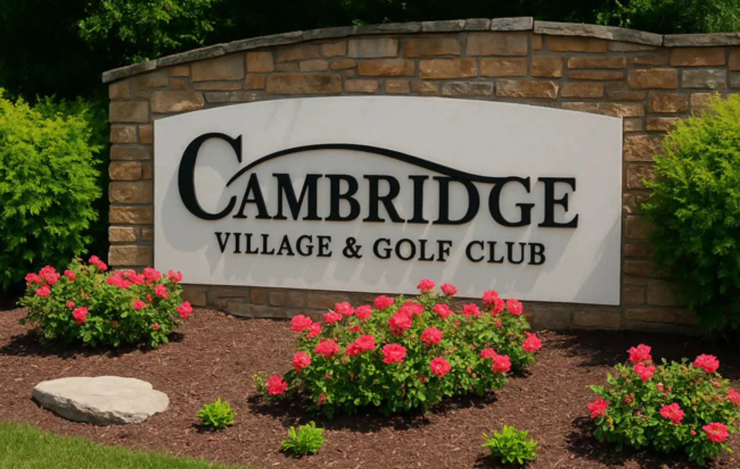 Cambridge Village and Golf Club entrance sign in Evansville, Indiana, surrounded by colorful landscaping.