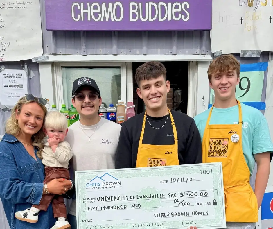 Five people present a $500 donation to Chemo Buddies, giving back to the community.