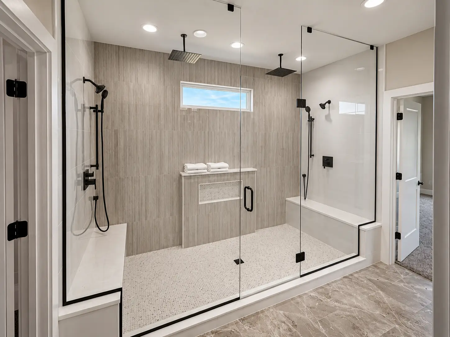 Modern bathroom gallery with glass wet room, dual rain showers, bench, and bathtub.