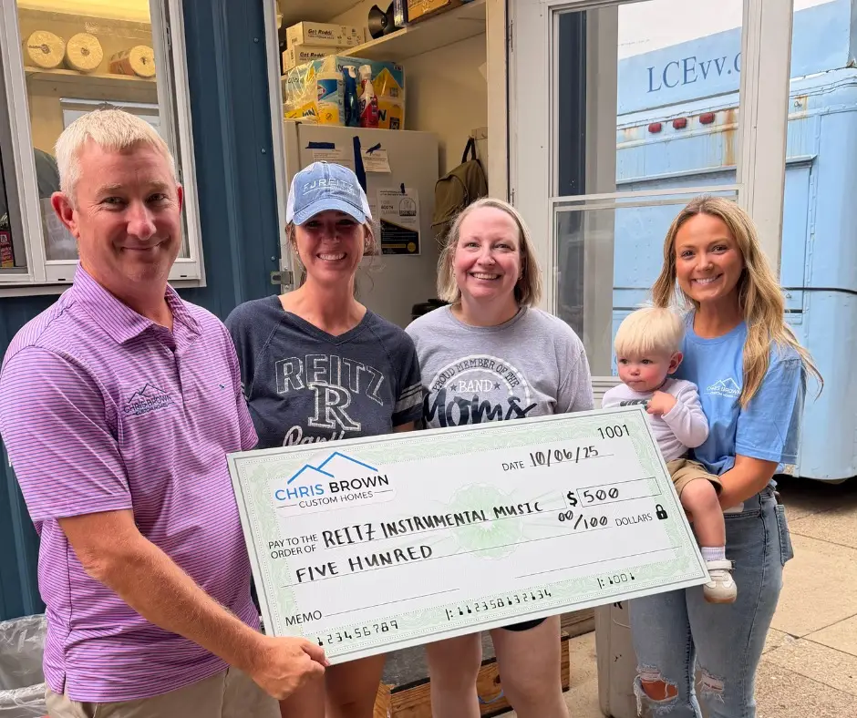 Group celebrates Chris Brown Custom Homes’ $500 donation to Reitz Instrumental Music.